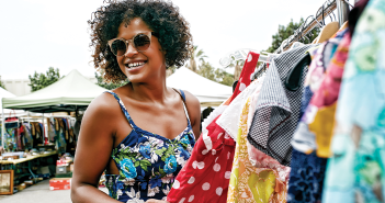 african american woman wearing sunglasses hopping for clothes outside