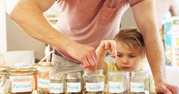 parent and child putting money in jars