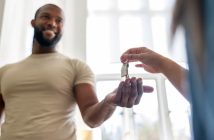 Someone handing a person keys to a house