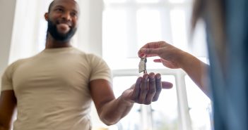 Someone handing a person keys to a house