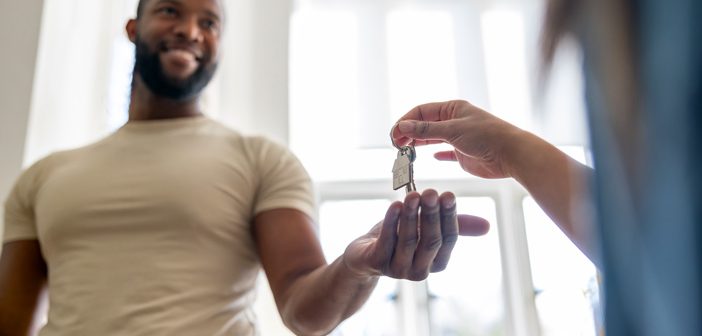 Someone handing a person keys to a house