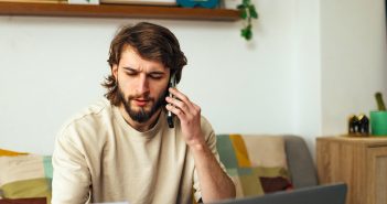 7 Actions To Take If You Suspect Identity Theft Or Fraud Person on a phone